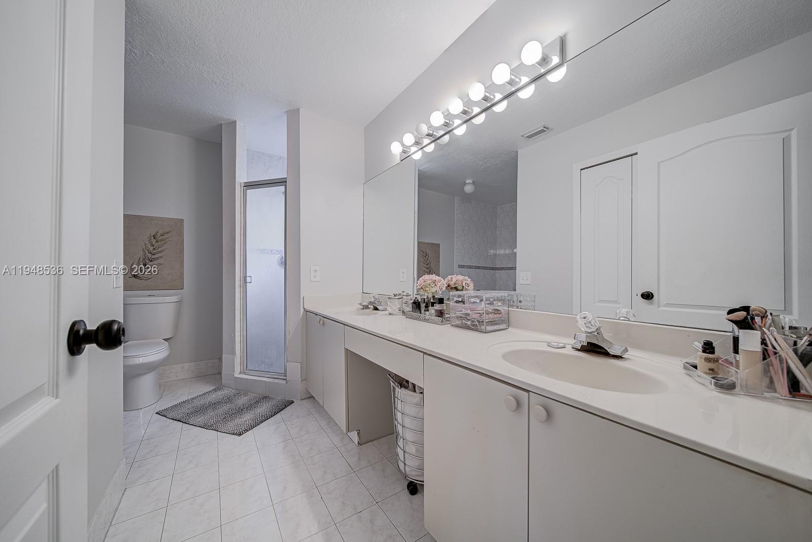 18128 Southwest 151st Avenue Miami, FL 33187 - Photo 14 of 39 a bathroom with a sink double vanity and a mirror