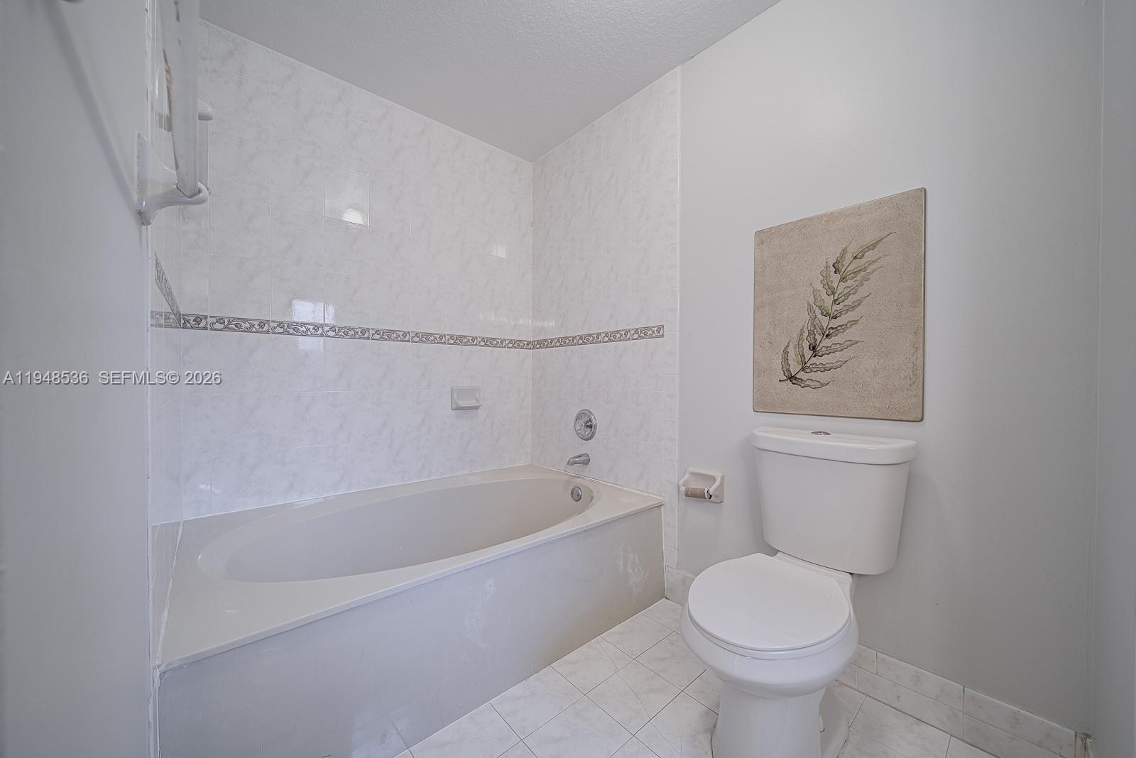 18128 Southwest 151st Avenue Miami, FL 33187 - Photo 15 of 39 a white toilet sitting next to a bath tub