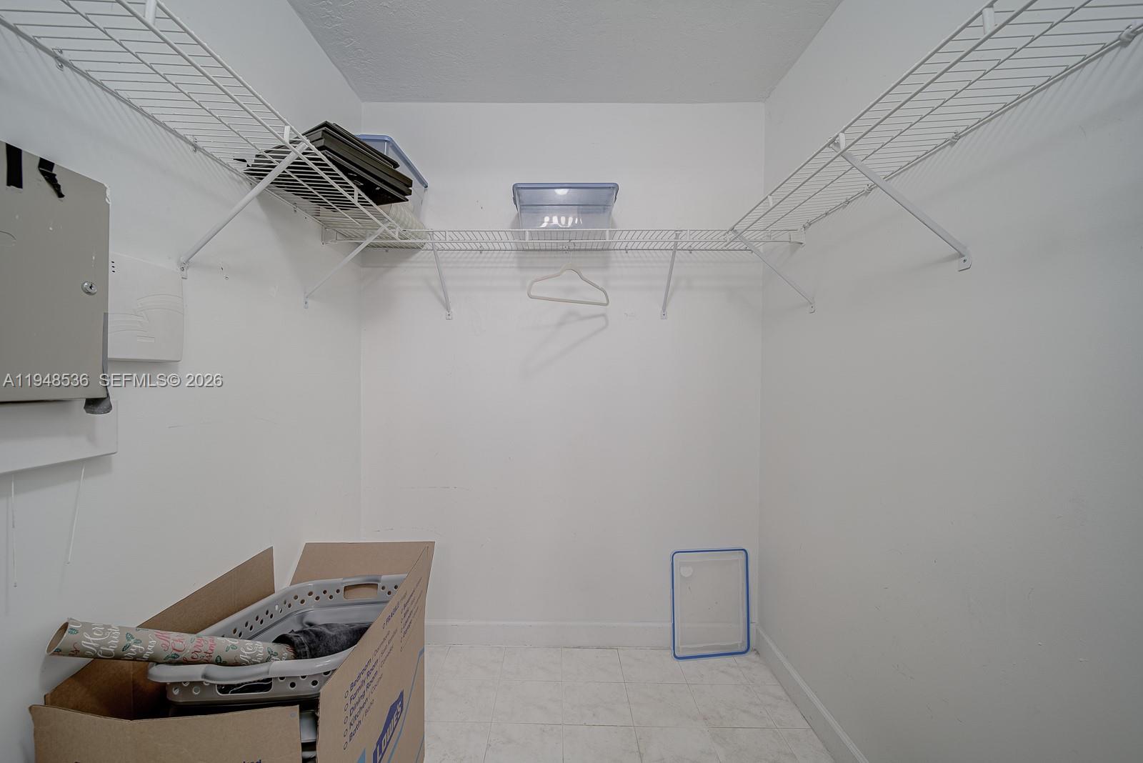 18128 Southwest 151st Avenue Miami, FL 33187 - Photo 16 of 39 a room with water heater and racks on the wall