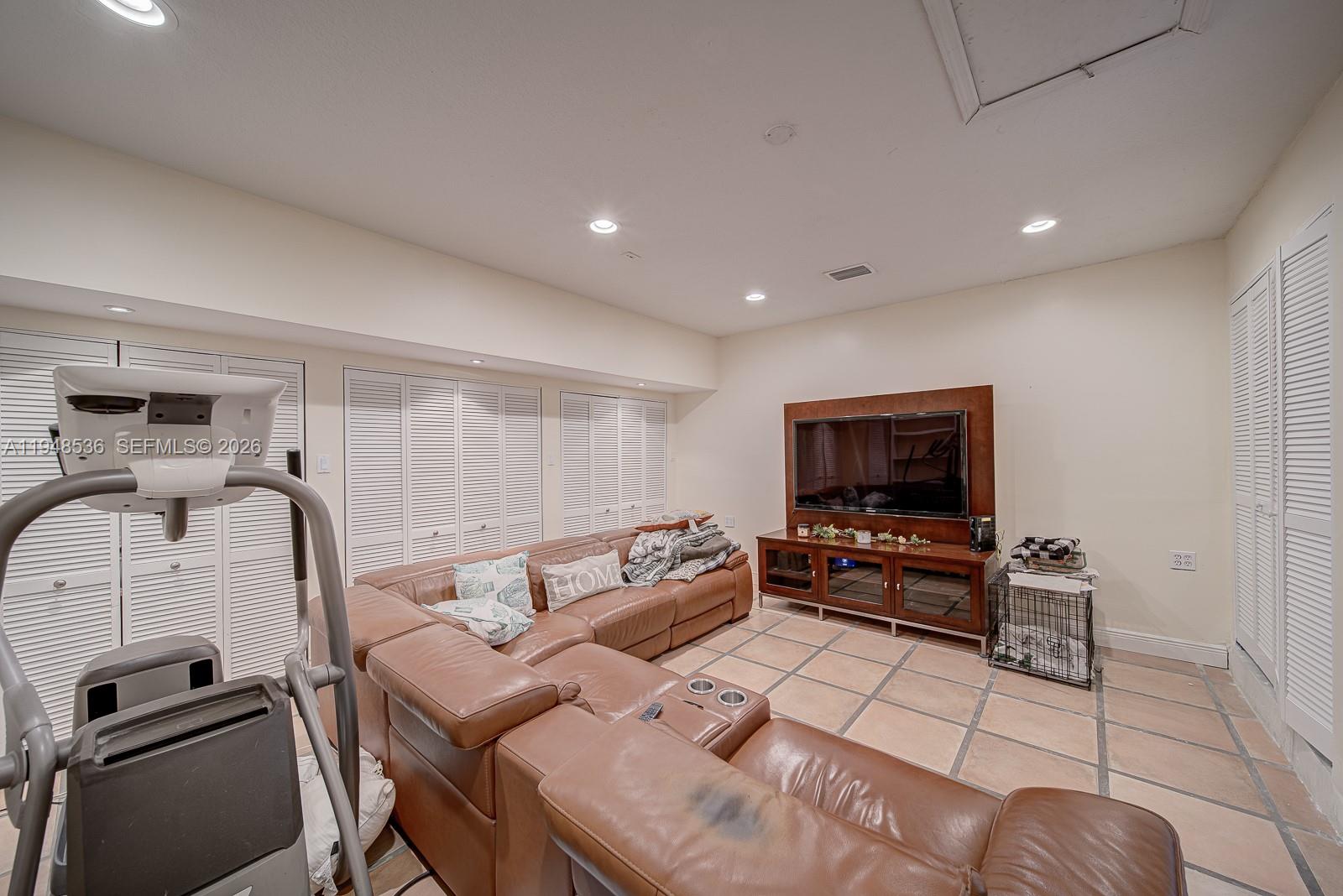 18128 Southwest 151st Avenue Miami, FL 33187 - Photo 19 of 39 a living room with furniture and a flat screen tv