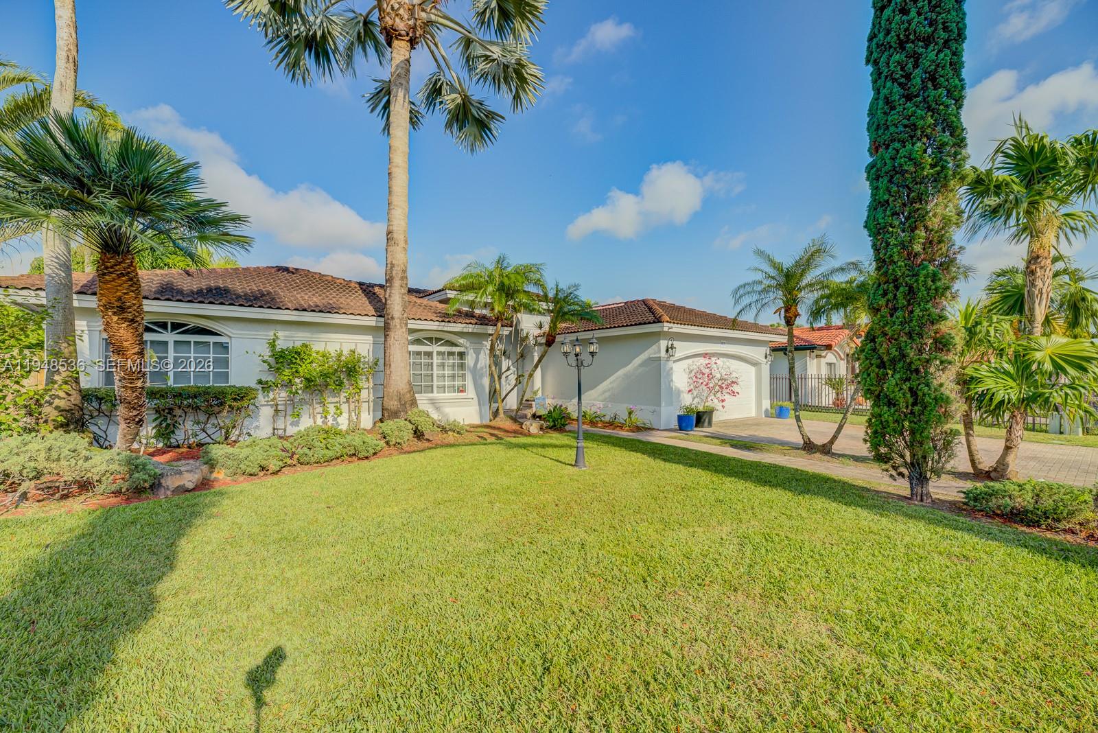 18128 Southwest 151st Avenue Miami, FL 33187 - Photo 2 of 39 a front view of house with yard and seating area