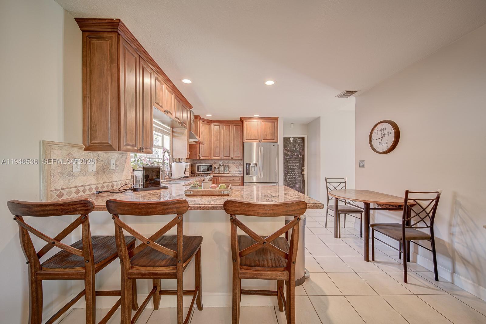 18128 Southwest 151st Avenue Miami, FL 33187 - Photo 26 of 39 a view of a dining area with furniture and a large window