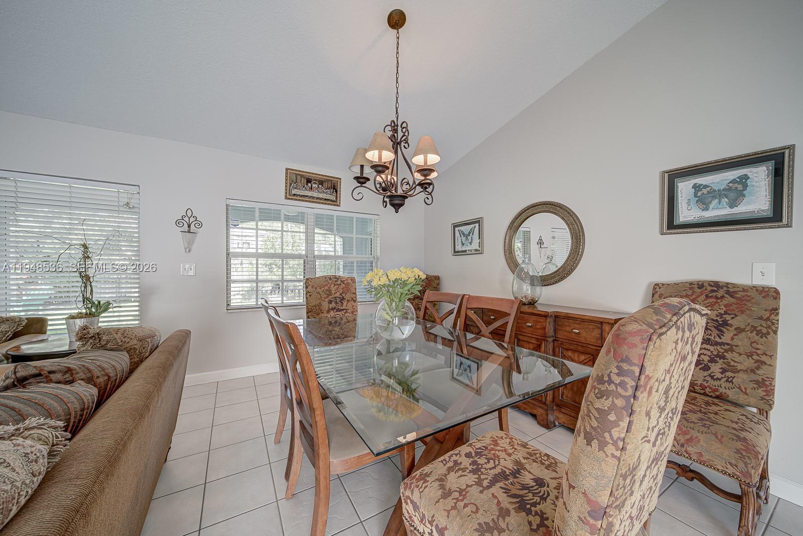 18128 Southwest 151st Avenue Miami, FL 33187 - Photo 30 of 39 a view of a dining room with furniture window and wooden floor