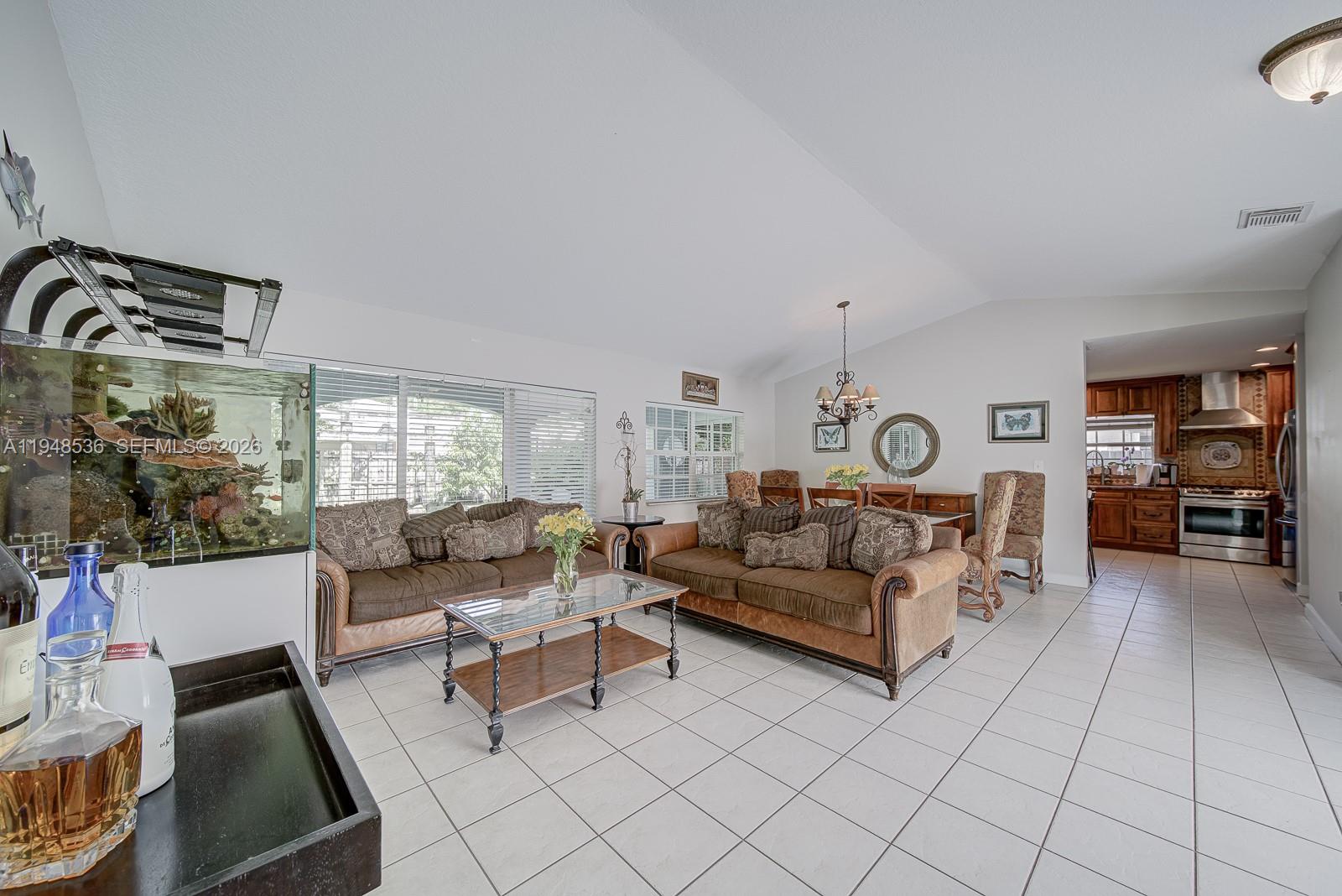 18128 Southwest 151st Avenue Miami, FL 33187 - Photo 31 of 39 a living room with furniture and white walls