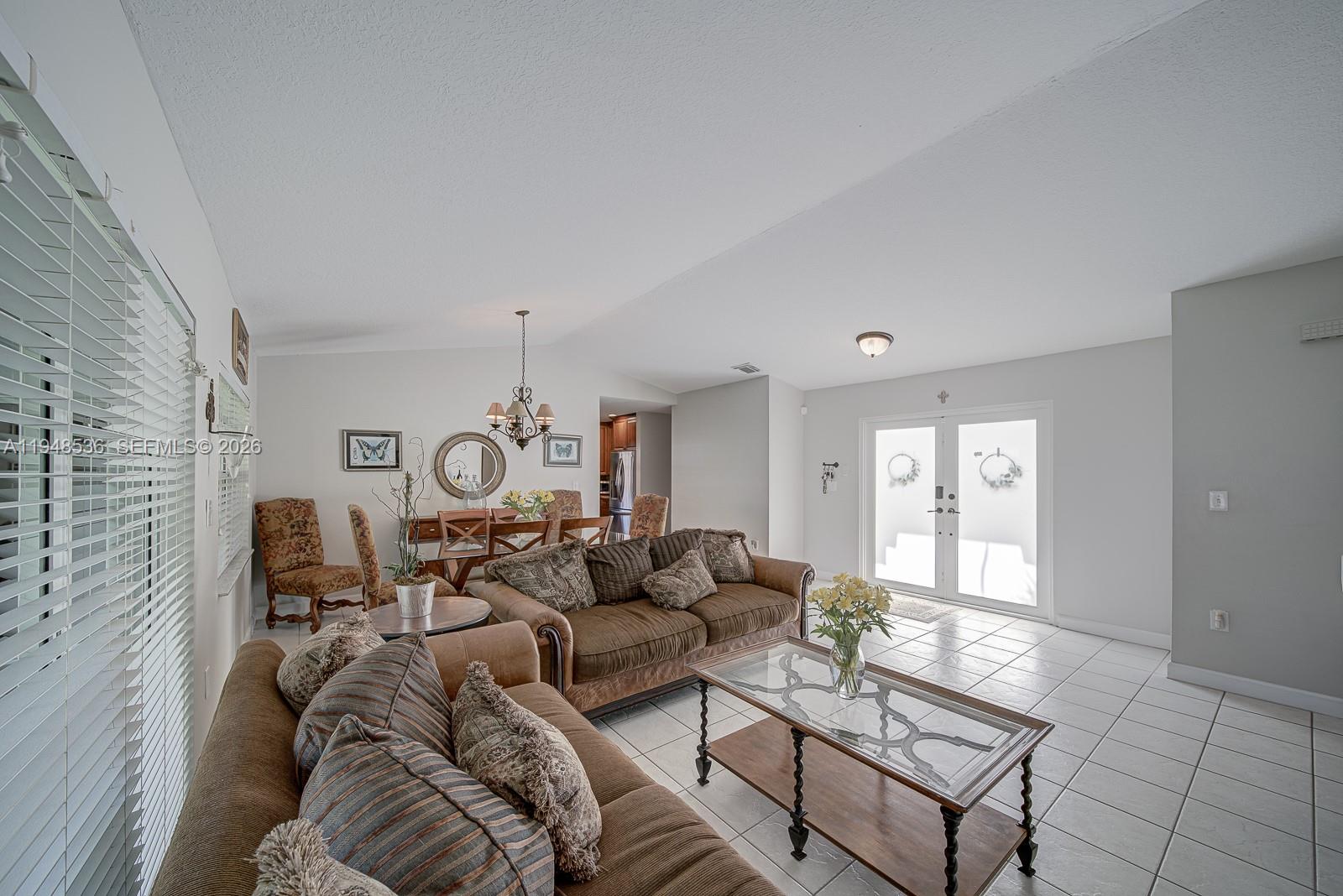 18128 Southwest 151st Avenue Miami, FL 33187 - Photo 32 of 39 a living room with furniture a clock and a window