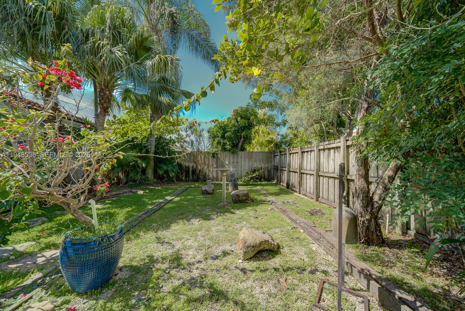 18128 Southwest 151st Avenue Miami, FL 33187 - Photo 35 of 39 a garden with wooden fence
