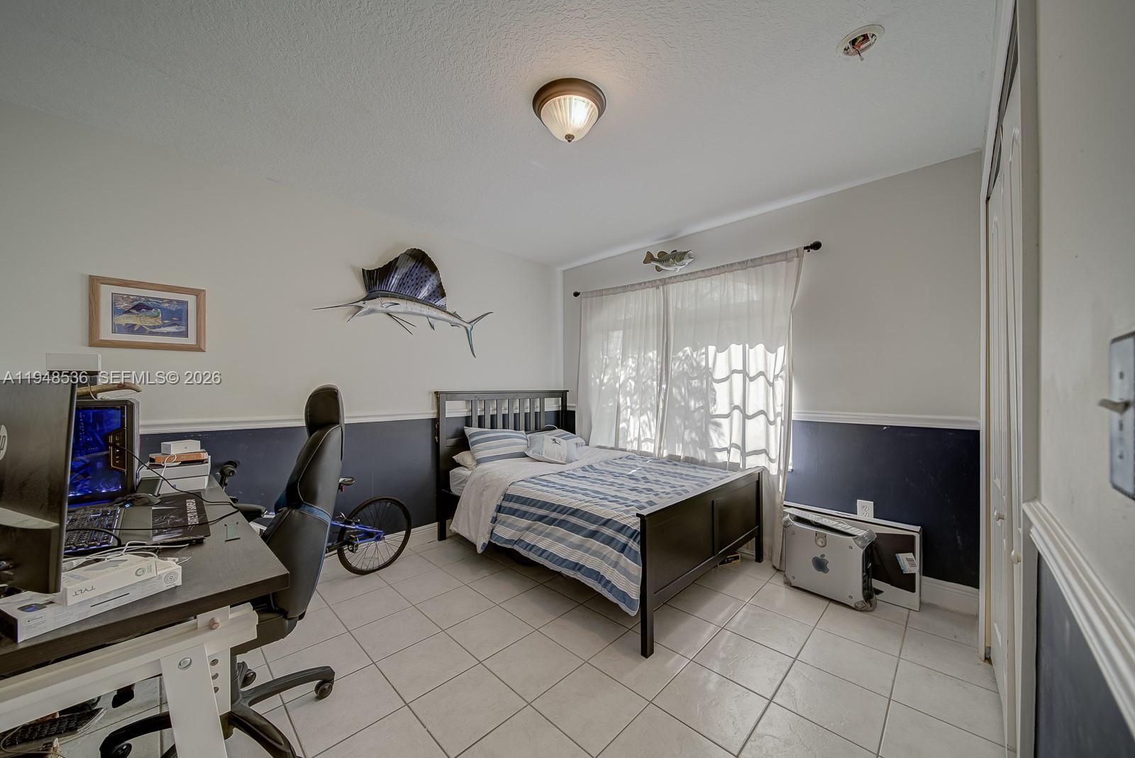 18128 Southwest 151st Avenue Miami, FL 33187 - Photo 6 of 39 a bedroom with bed and a window