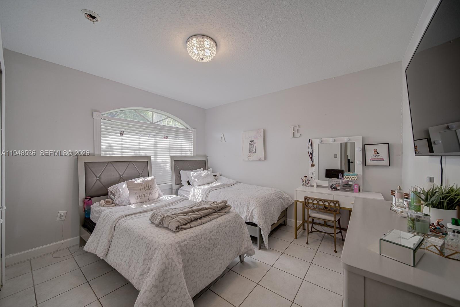 18128 Southwest 151st Avenue Miami, FL 33187 - Photo 8 of 39 a bedroom with a bed and a chair