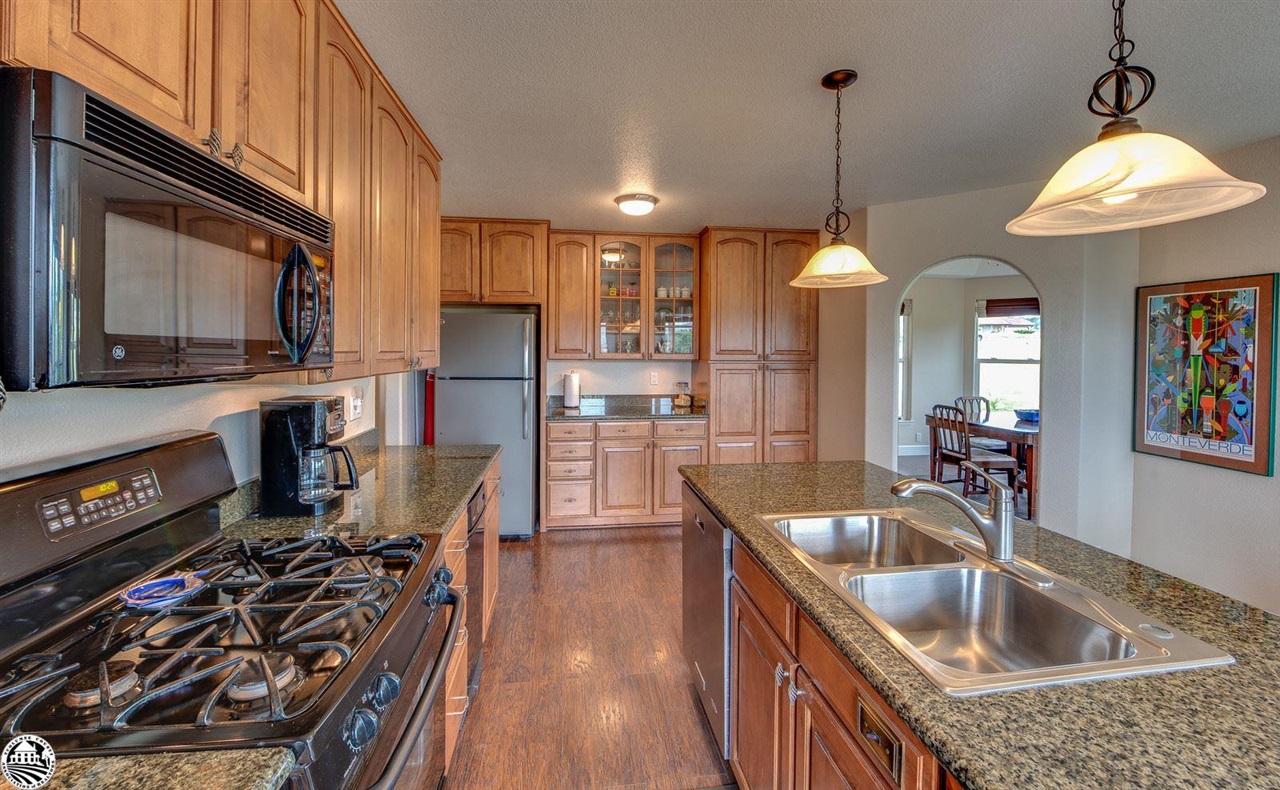 1618 Cheyenne Road Copperopolis, CA 95228 - Photo 12 of 30 a kitchen with stainless steel appliances granite countertop a sink stove and refrigerator