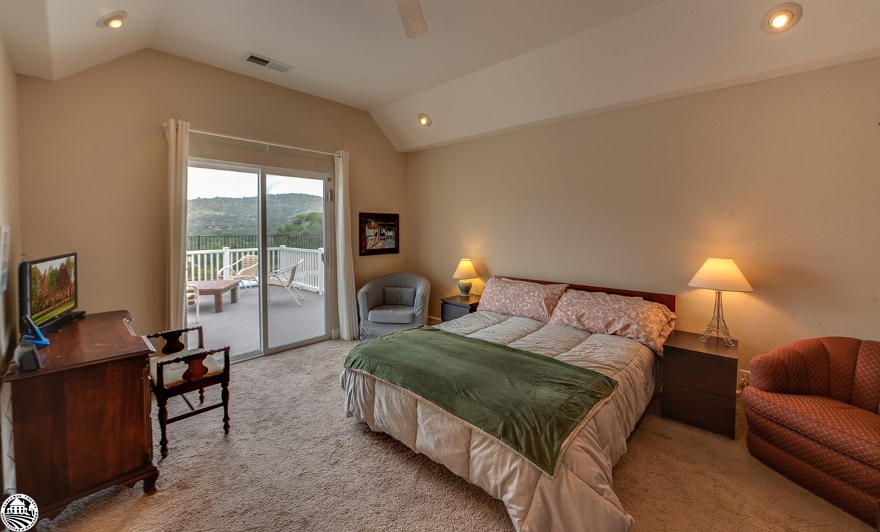 1618 Cheyenne Road Copperopolis, CA 95228 - Photo 15 of 30 a spacious bedroom with a bed and large windows