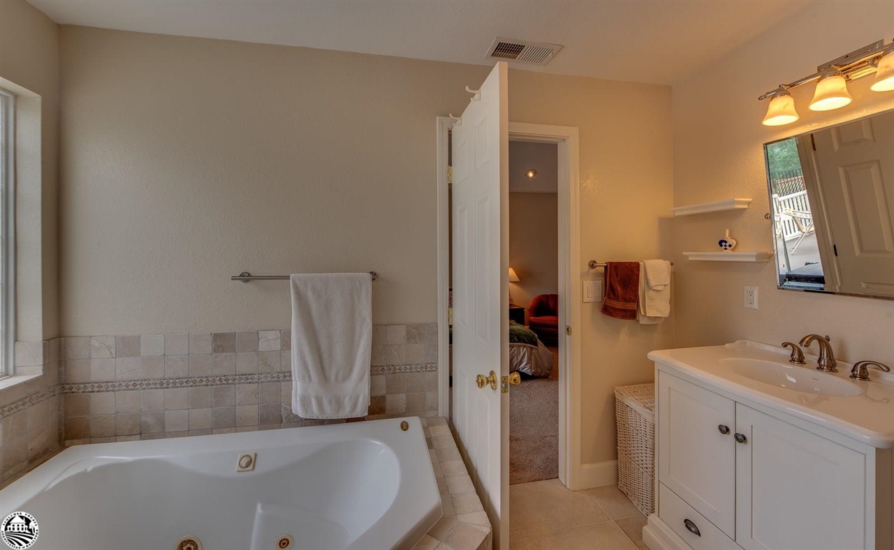 1618 Cheyenne Road Copperopolis, CA 95228 - Photo 17 of 30 a bathroom with a tub sink and mirror
