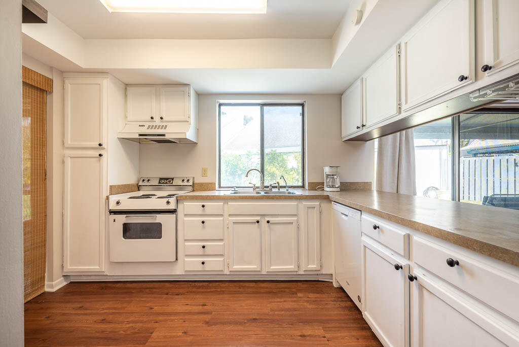 231 Northwest 15th Street Boca Raton, FL 33432 - Photo 8 of 22 a kitchen with granite countertop white cabinets and white appliances