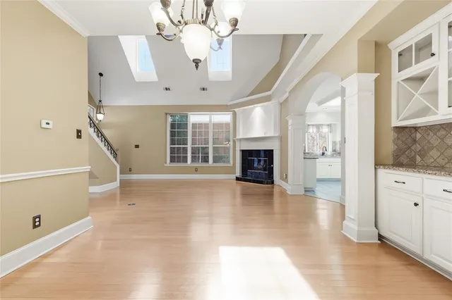 a view of an empty room with a fireplace and a window