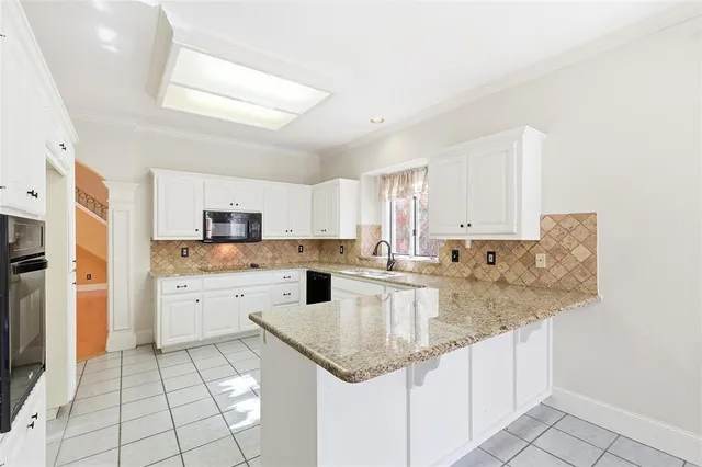 a kitchen with stainless steel appliances granite countertop a sink dishwasher and cabinets with wooden floor