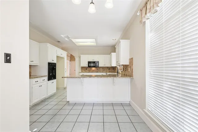 a kitchen with stainless steel appliances a refrigerator sink and microwave