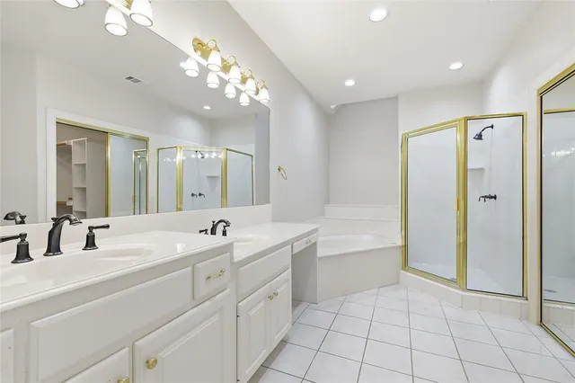 a bathroom with a bathtub a sink and a mirror