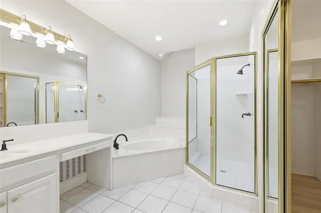 a bathroom with a bathtub shower sink double and mirror