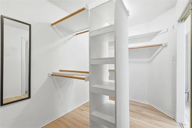 a view of closet with wooden floor