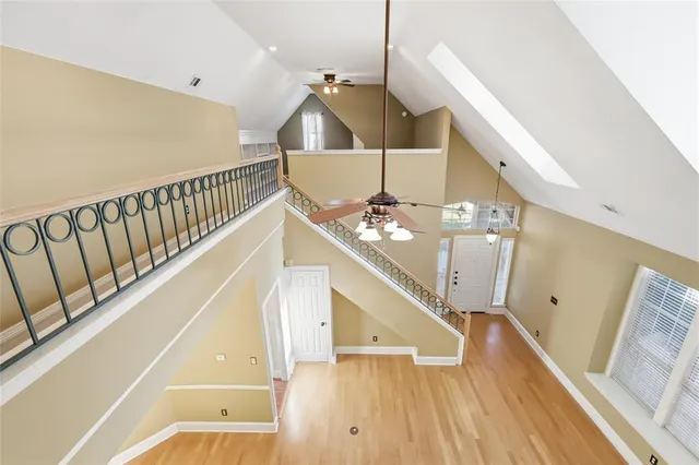 a view of staircase with railing and white walls