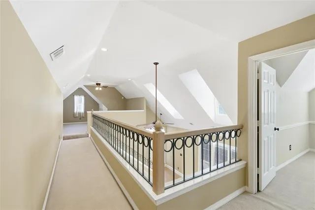 an empty room with windows and ceiling fan