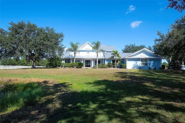 a front view of a house with a yard table and chairs