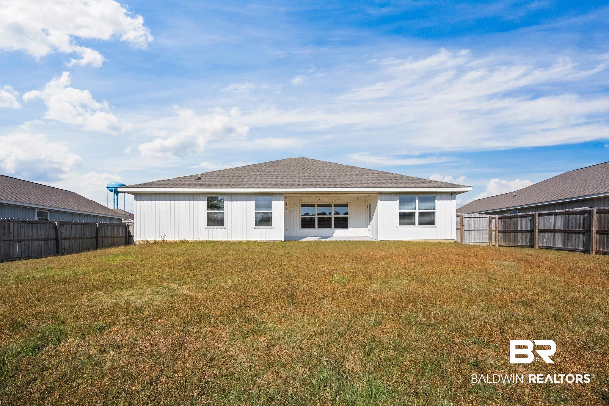 3090 Camino Real Loop Lillian, AL 36549 - Photo 7 of 29 Back of property featuring a patio and a fenced backyard