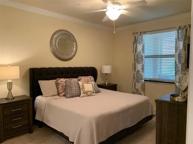 a bedroom with a bed and a chandelier