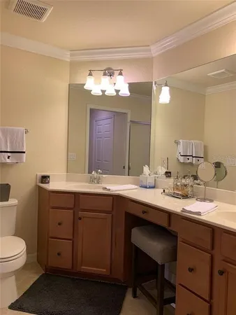 a bathroom with a double vanity sink and a toilet