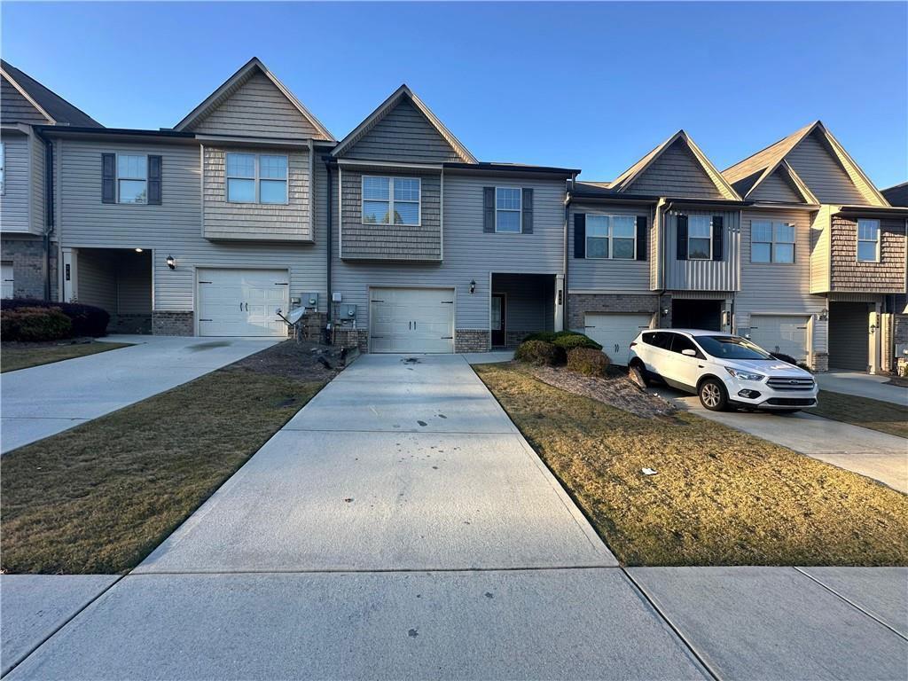 346 Turtle Creek Drive Winder, GA 30680 - Photo 1 of 11 a front view of a house with yard and parking