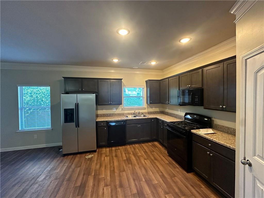 346 Turtle Creek Drive Winder, GA 30680 - Photo 3 of 11 a kitchen with stainless steel appliances granite countertop a refrigerator a sink dishwasher a stove and a microwave oven on wooden floor