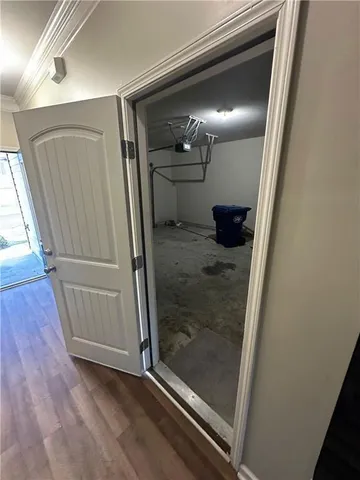 a view of a hallway with wooden floor
