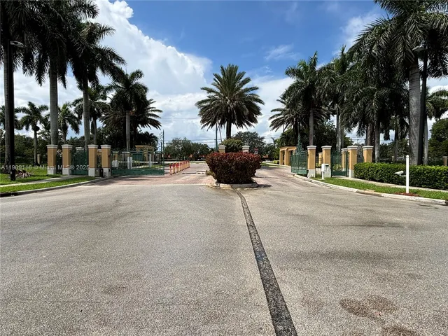 a group of palm trees in front of a building