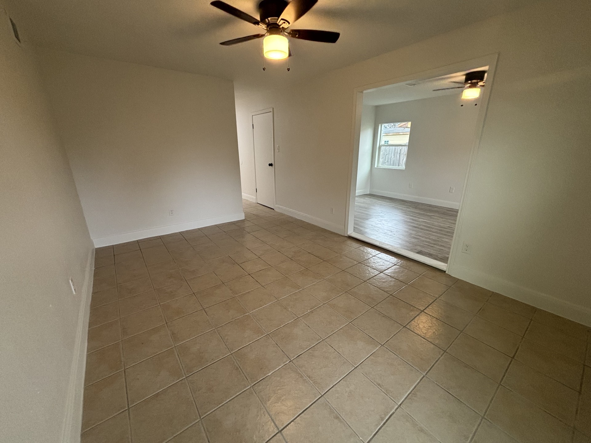 9843 Ribbonwood Street Houston, TX 77078 - Photo 2 of 14 an empty room with windows and fan chandelier