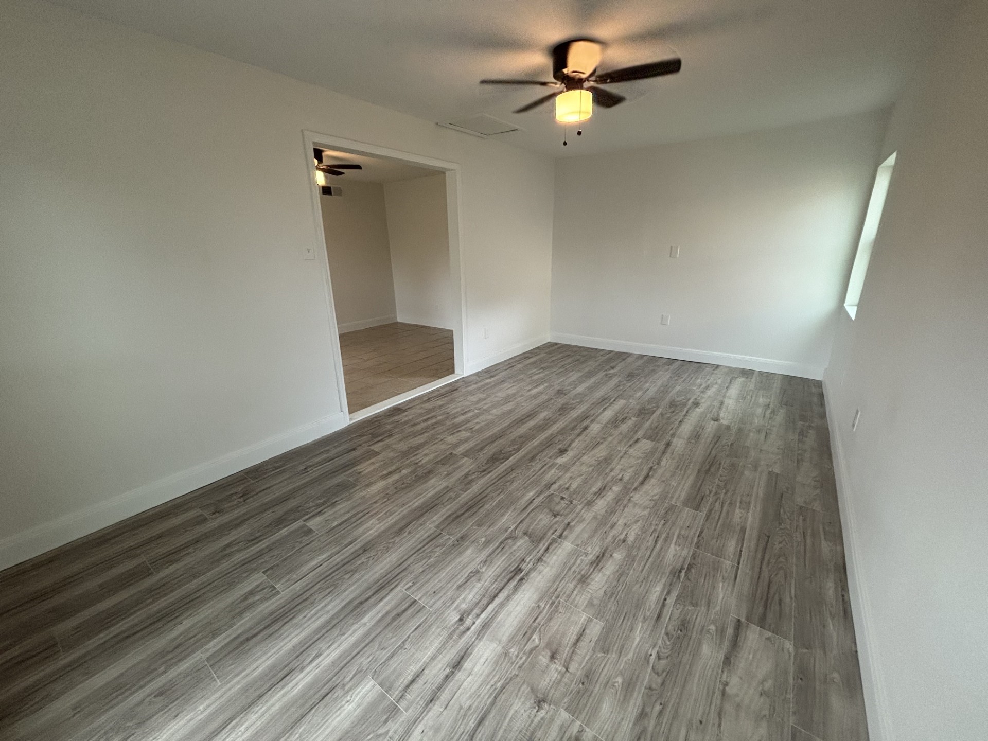 9843 Ribbonwood Street Houston, TX 77078 - Photo 5 of 14 wooden floor in an empty room with a window