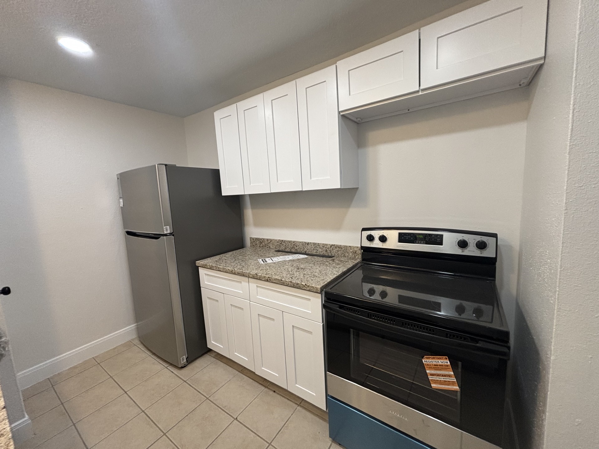 9843 Ribbonwood Street Houston, TX 77078 - Photo 6 of 14 a kitchen with a stove and a refrigerator