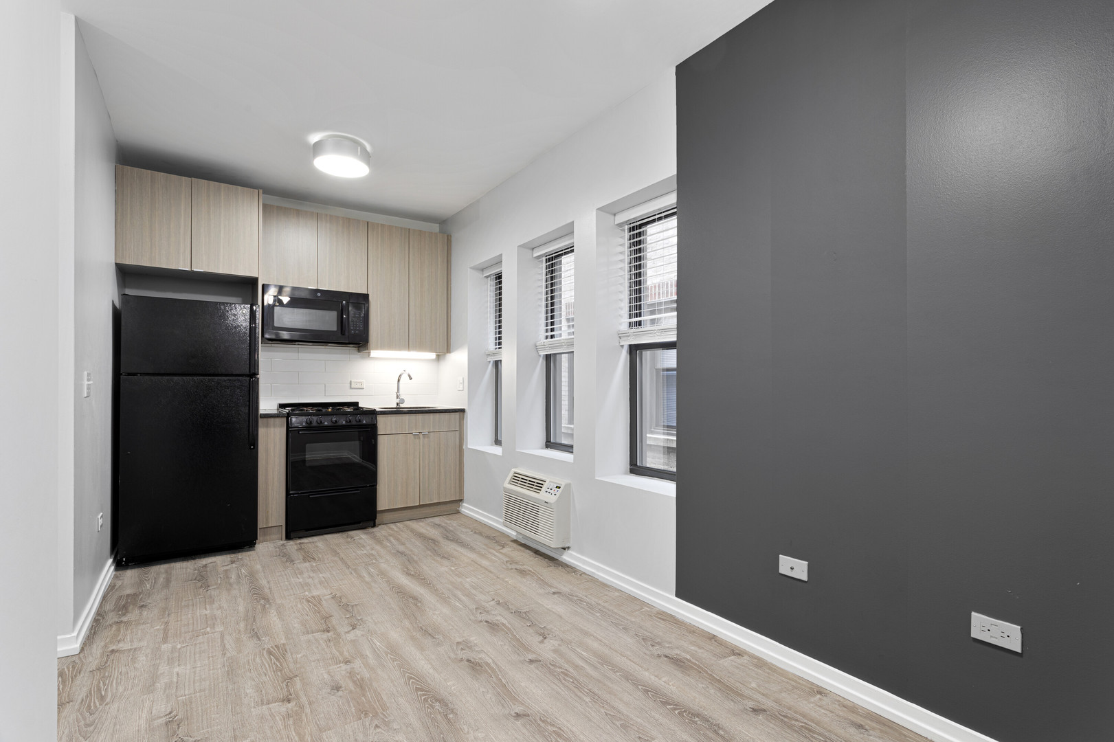 4875 North Magnolia Avenue, Unit 112 Chicago, IL 60640 - Photo 2 of 12 a kitchen with a refrigerator and a stove