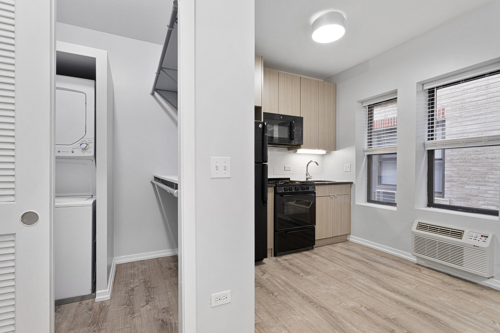 4875 North Magnolia Avenue, Unit 112 Chicago, IL 60640 - Photo 4 of 12 a kitchen with stainless steel appliances granite countertop a refrigerator and a stove