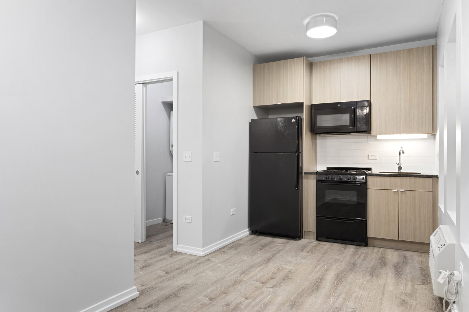 4875 North Magnolia Avenue, Unit 112 Chicago, IL 60640 - Photo 5 of 12 a kitchen with granite countertop a refrigerator and a stove top oven