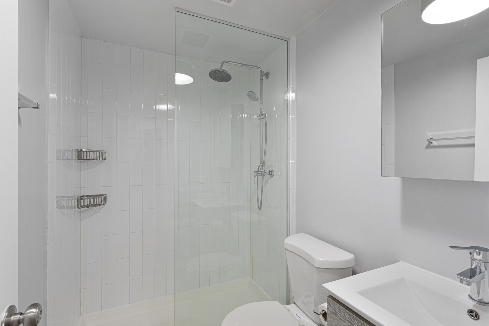 4875 North Magnolia Avenue, Unit 112 Chicago, IL 60640 - Photo 8 of 12 a bathroom with a toilet a sink and shower