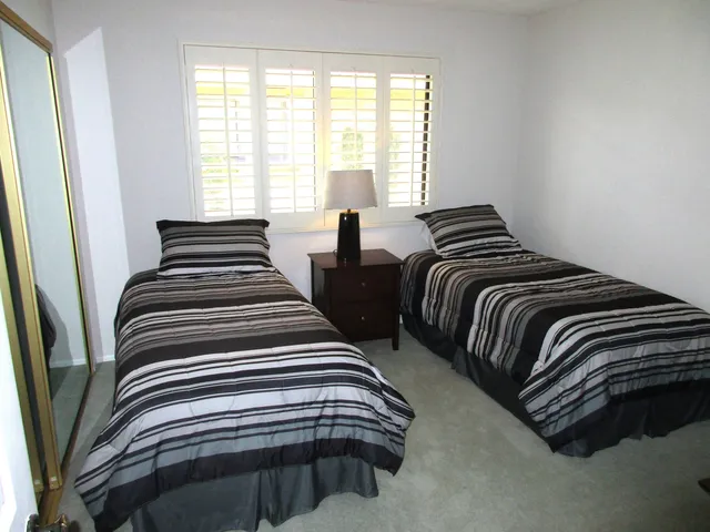 a bedroom with double bed and a window