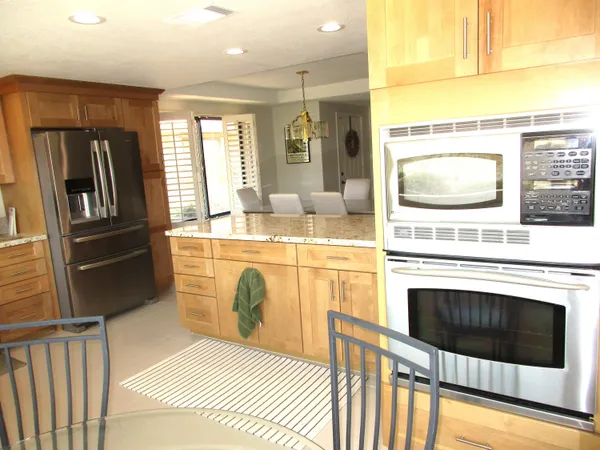 a kitchen with stainless steel appliances a stove a sink and a refrigerator