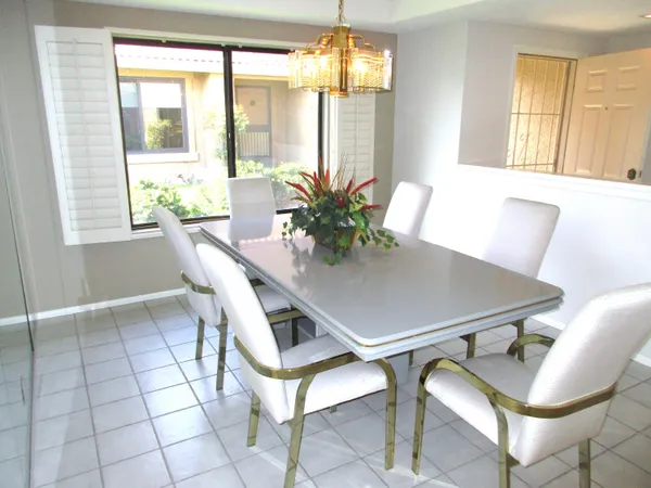 a view of a dining room with furniture and a window