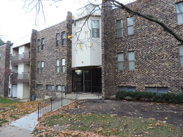 a brick building with a sink and a yard