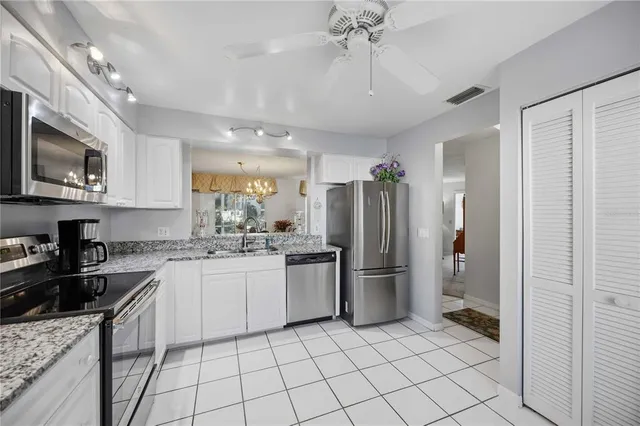 a kitchen with a refrigerator a sink and cabinets