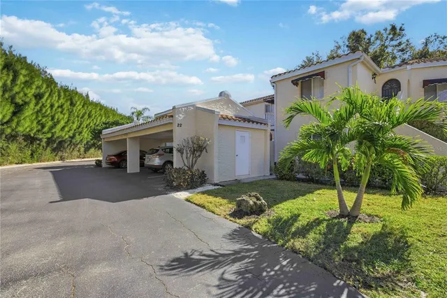 a front view of a house with garden and parking