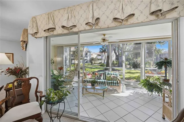 a view of a porch with a dining table and chairs
