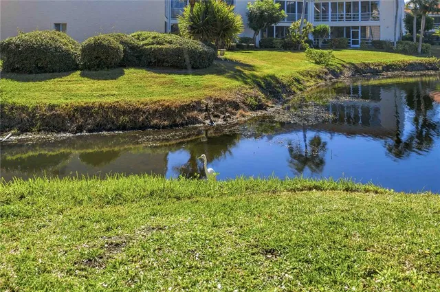 a view of a water with a house in the background