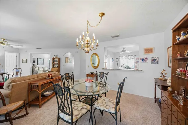 a view of a dining room with furniture and chandelier