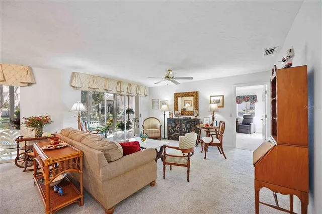 a living room with furniture a lamp and a window