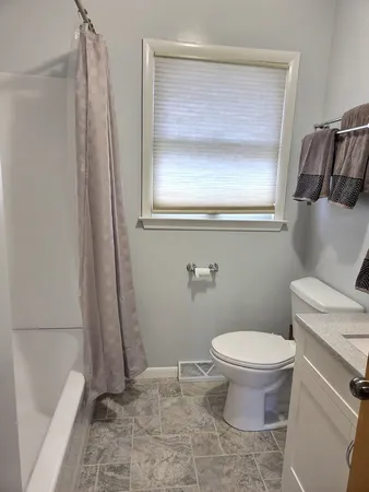 a bathroom with a toilet and a shower